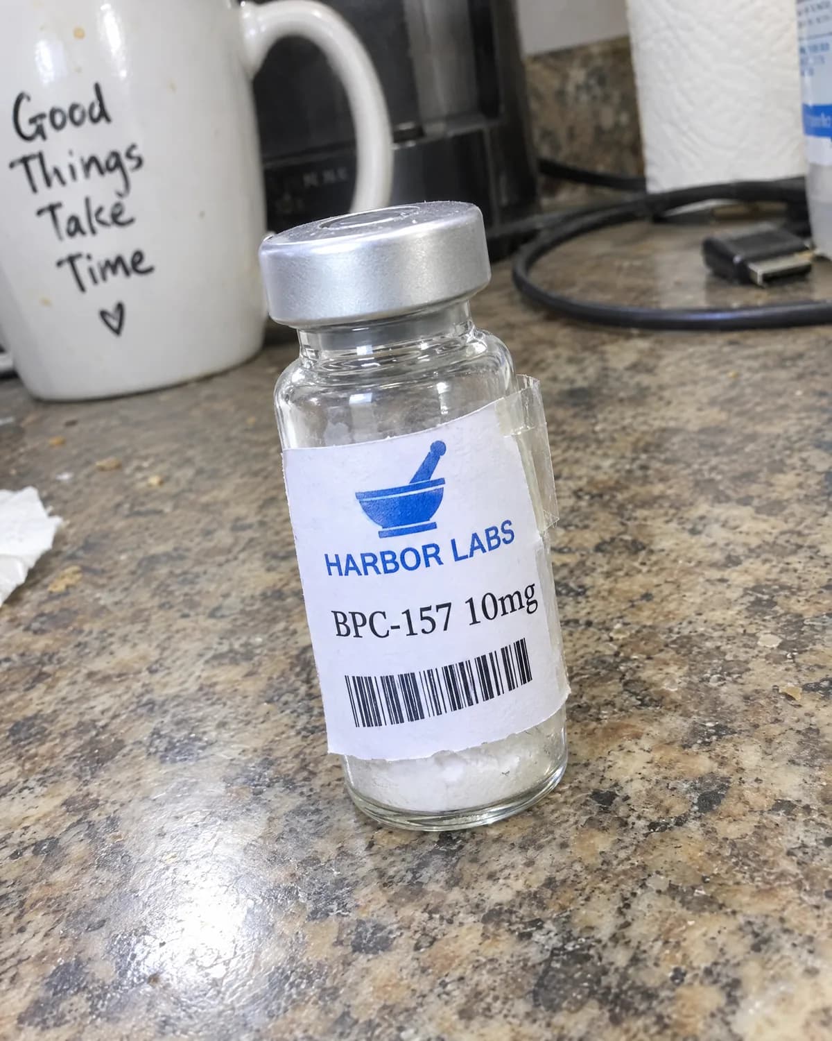 Before: a home-printed Harbor Labs label taped to a vial on a kitchen counter.